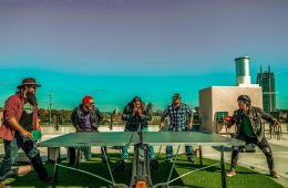 press photo pf Chip McGuire Band playing ping pong on an Atlanta rooftop.