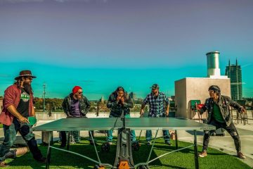 press photo pf Chip McGuire Band playing ping pong on an Atlanta rooftop.
