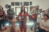 still from the set of the Karaoke video featuring the band performing.