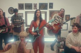 still from the set of the Karaoke video featuring the band performing.