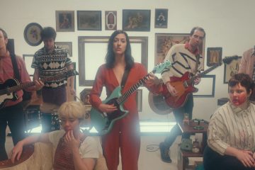 still from the set of the Karaoke video featuring the band performing.