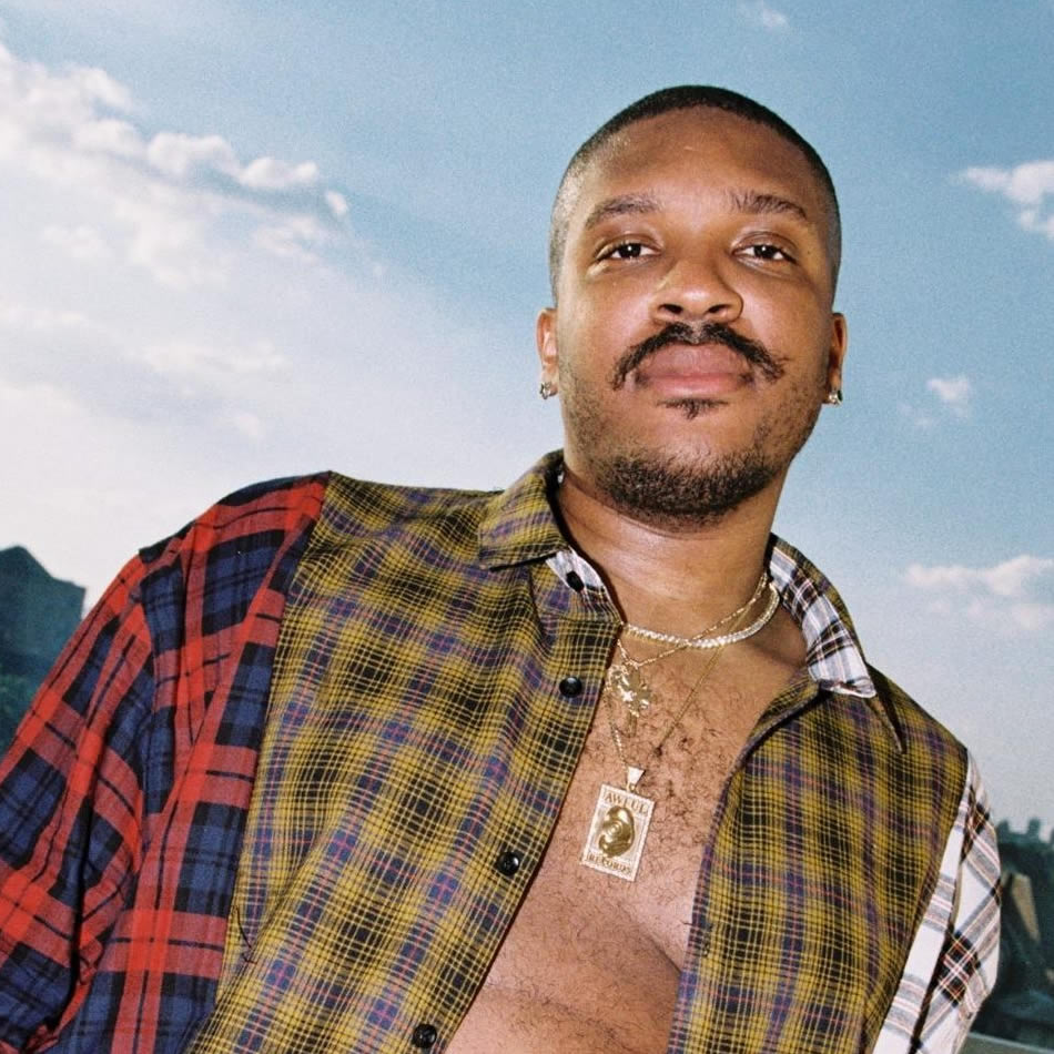 photo of Father with open shirt, wearing an Awful Records necklace.
