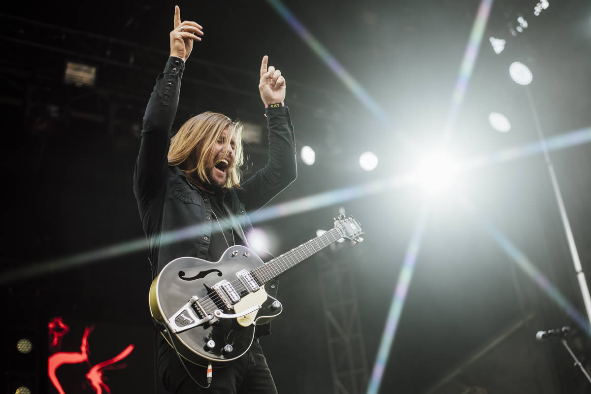 Band of Skulls guitarist with hands above head