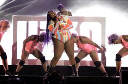 Lizzo performing with dancers behind her.