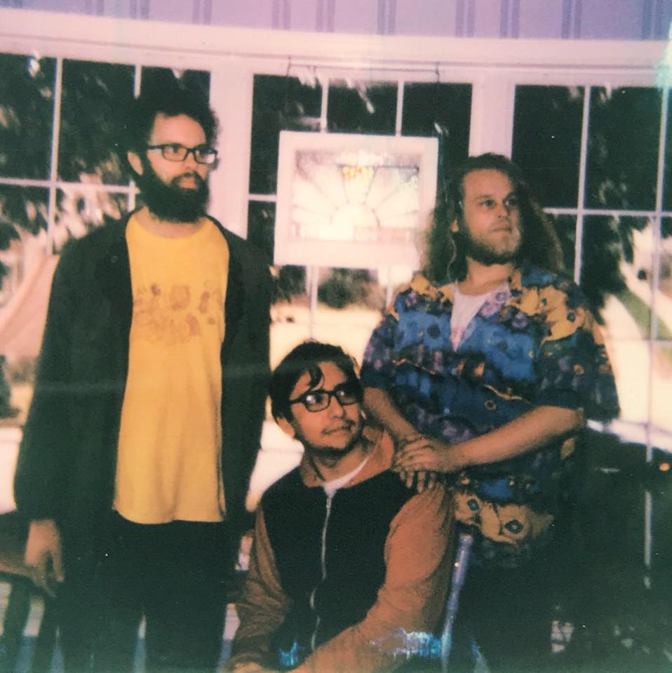 Members of Dead Neigbors, two standing and one sitting