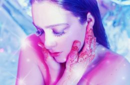 Jennifer Zuiff with eyes closed and henna tattoos