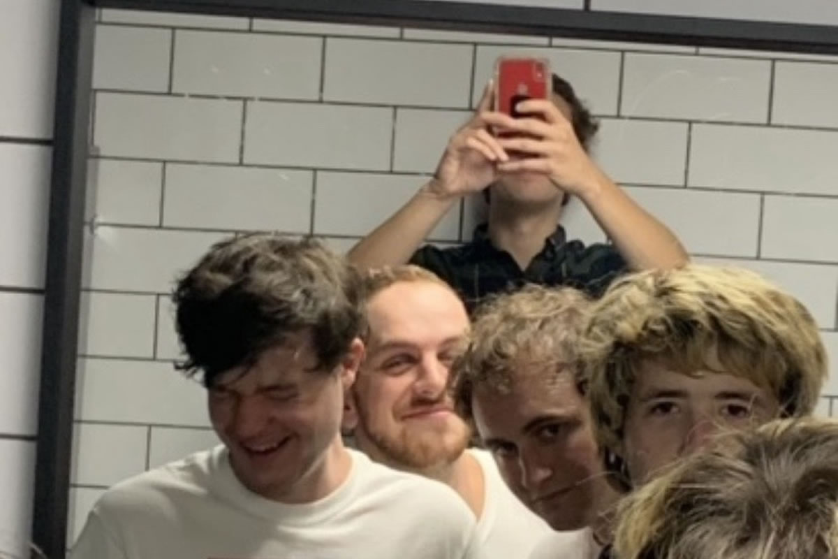 members of Jack's Johnson in front of a mirror