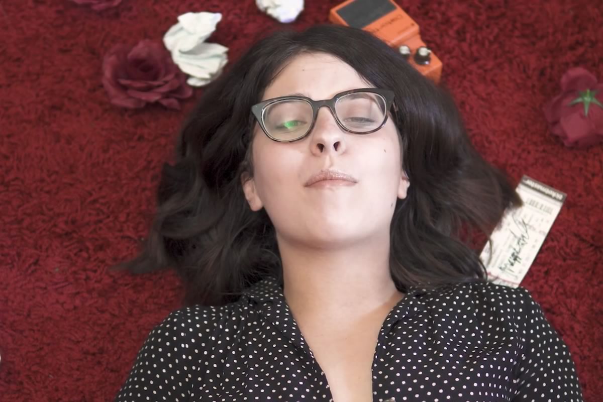 Maggie Schneider lying on a carpet with roses