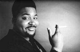 Man in a suit holding a cigarette