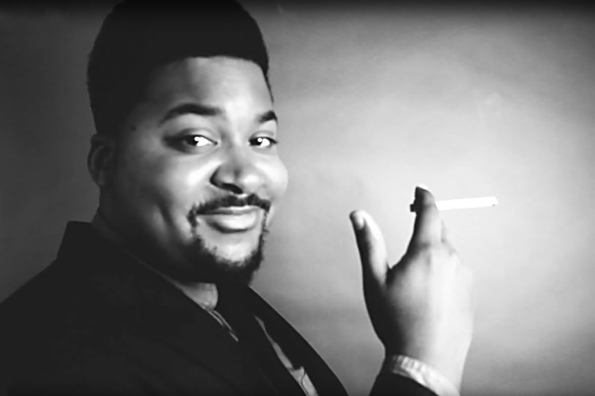 Man in a suit holding a cigarette