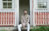 David Norbery sitting on the steps of a porch.