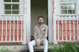David Norbery sitting on the steps of a porch.