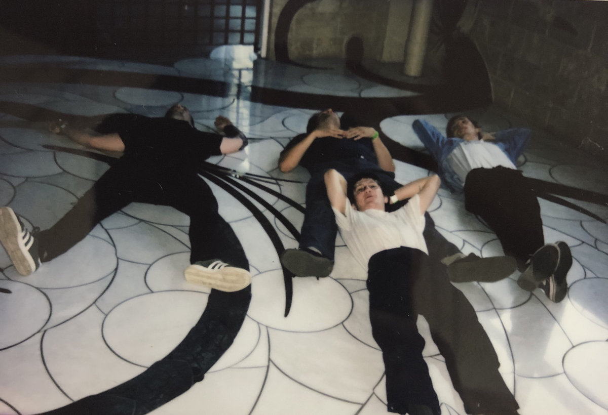 members of Warm Red lying on the floor