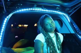 Yani Mo sitting in the back of a hatchback car