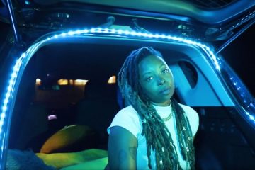 Yani Mo sitting in the back of a hatchback car