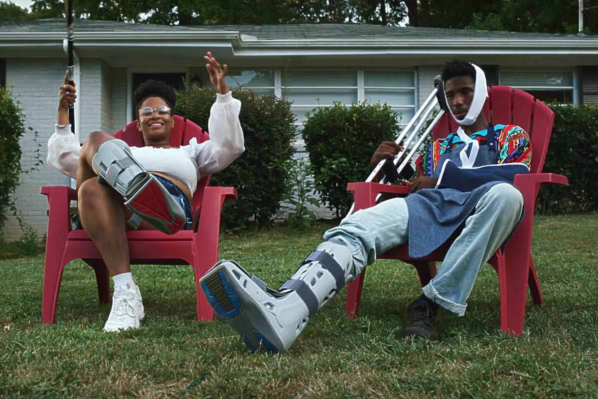 rapper BOREGARD and woman siting in chairs on front lawn