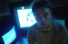 man in front of two television screens