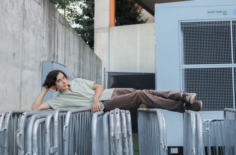 John Michael Young lounging on guard rails