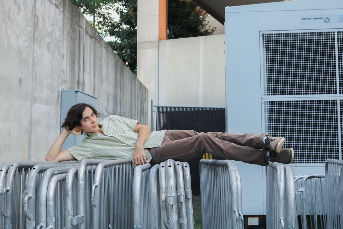 John Michael Young lounging on guard rails