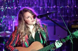 Kristen Englenz playing an acoustic guitar