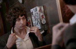 Rollingchild looking into a mirror and popping up his collar