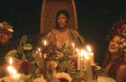 Seersha sitting in a chair at the end of a banquet table.