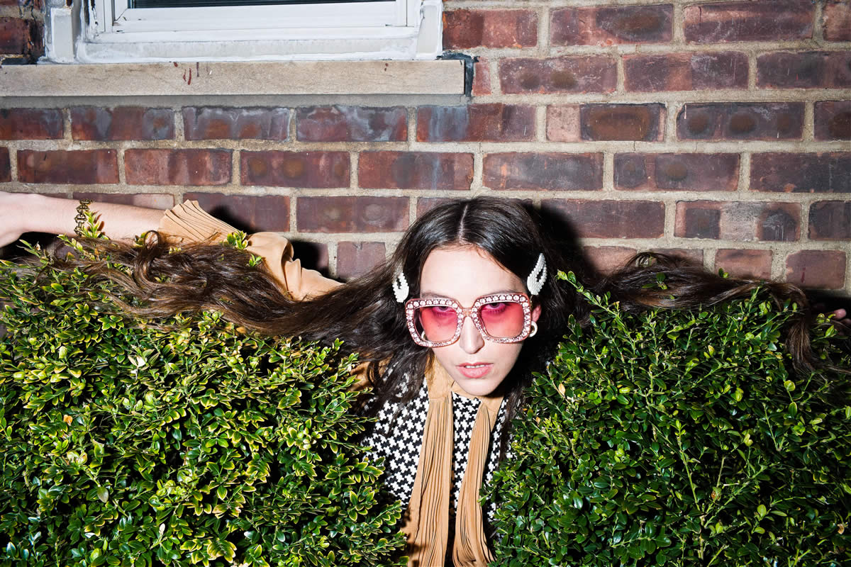 Nadia Marie crouching in a bush