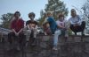 Members of Silver Lake Waves sitting on a wall.