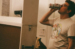 Justin Green of Mountain PArty drinking a Budweiser in the studio.