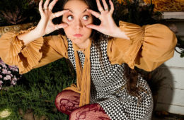 Nadia Marie crouching down and making bug eyes.