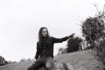 Nick Whitson of Phantom Electric sitting down and pointing