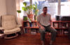 George Huntington sitting in a chair in his living room.