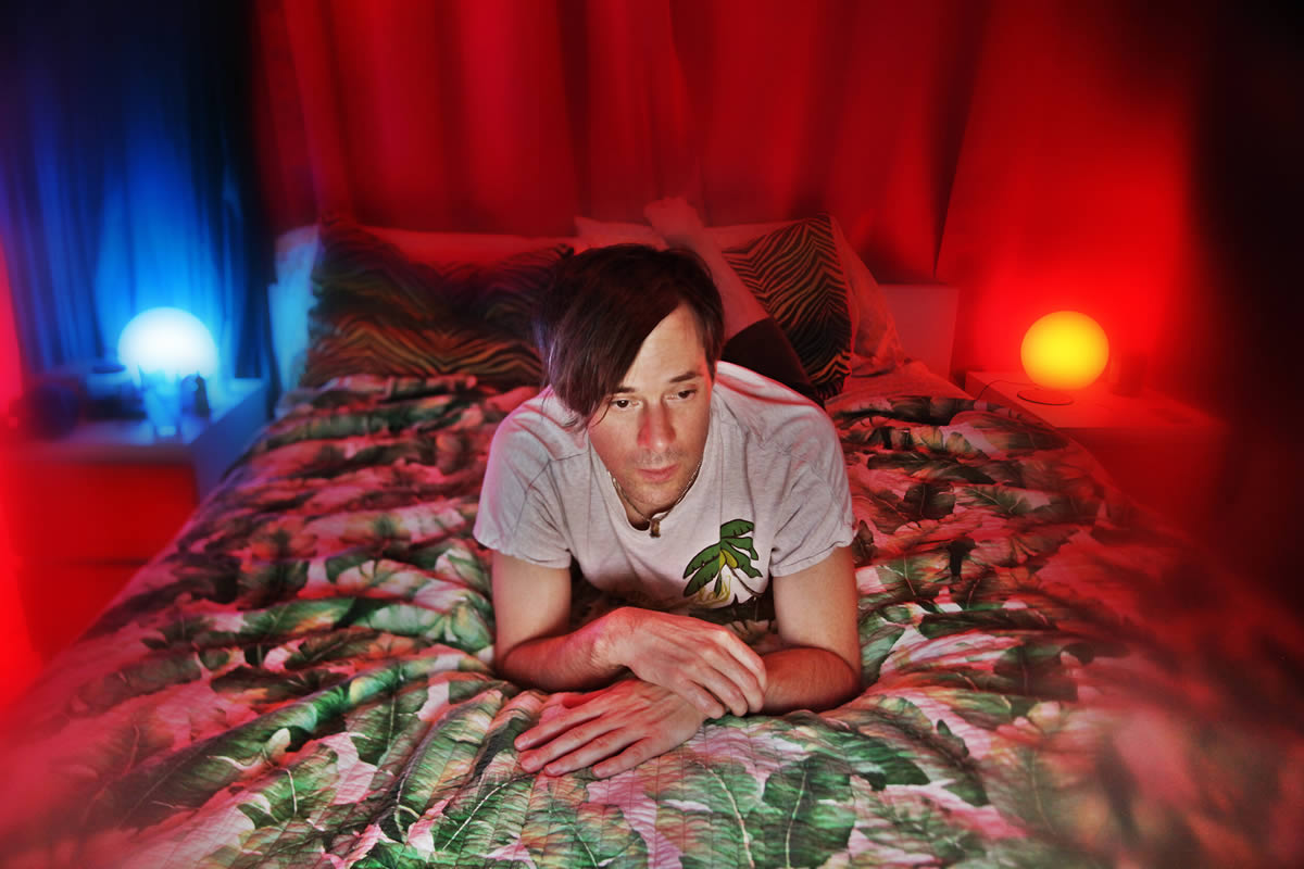 Kevin Barns of of Montreal lying in bed