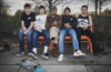 members of Upchuck sitting on a bench.