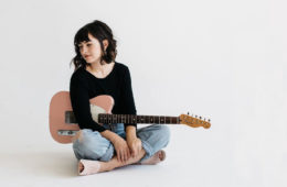 Casey Harper holding pink guitar