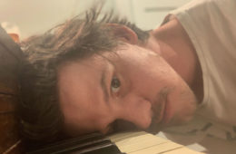 Tedo Stone with head on piano