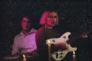 Steph Rinzler and Josh Hughes of Stevie Dinner playing with candles around them