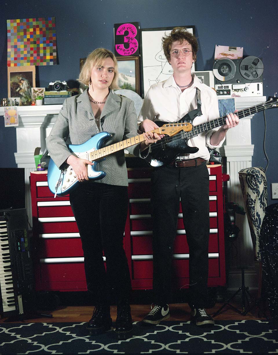 Steph Rinzler and Josh Hughes of Stevie Dinner standing and holding their guitars