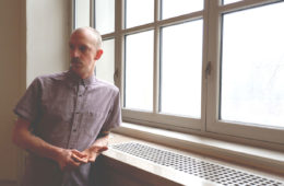 Jason Howell standing next to a window