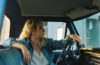 Jordan Reynolds of Rose Hotel sitting in a pickup truck
