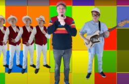 man in a baseball cap standing in a multi-colored backdrop