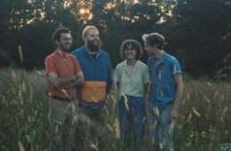 members of bandanna standing in an open field