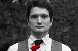 Black and white photo of Sean Bryant of Big Brutus with red rose