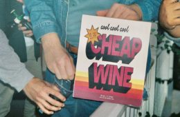 Man pouring wine out of a box that reads Cool Cool Cool Cheap Wine