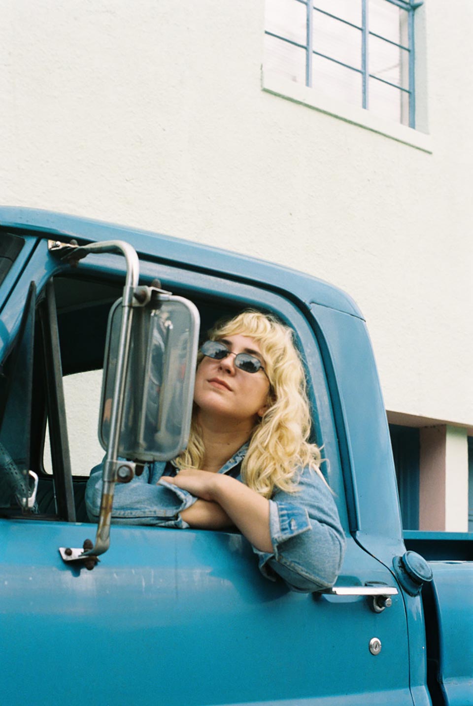 Jordan Reynolds of Rose Hotel in a blue pickup truck