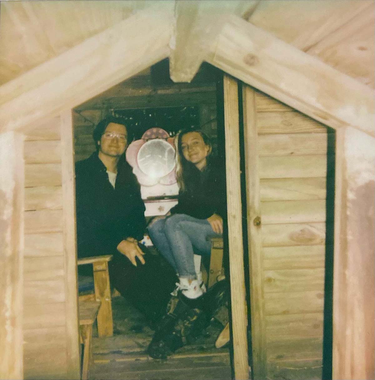 Tommy and Holyn Trautwein sitting in a small room with plain wooden walls