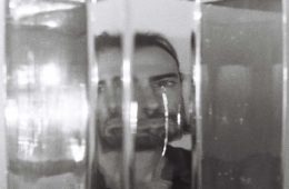 portrait of Chandler Kelley of Canopy Joc distorted through glass vases