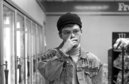 Cannon Rogers touching his nose in a grocery store aisle