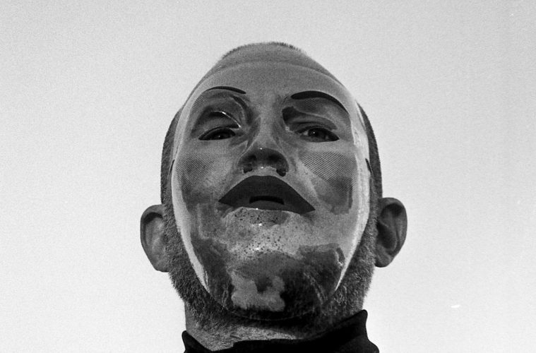 Ian Deaton wearing a silver mask