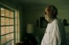 still from Easter Island video of an older man staring out of a window